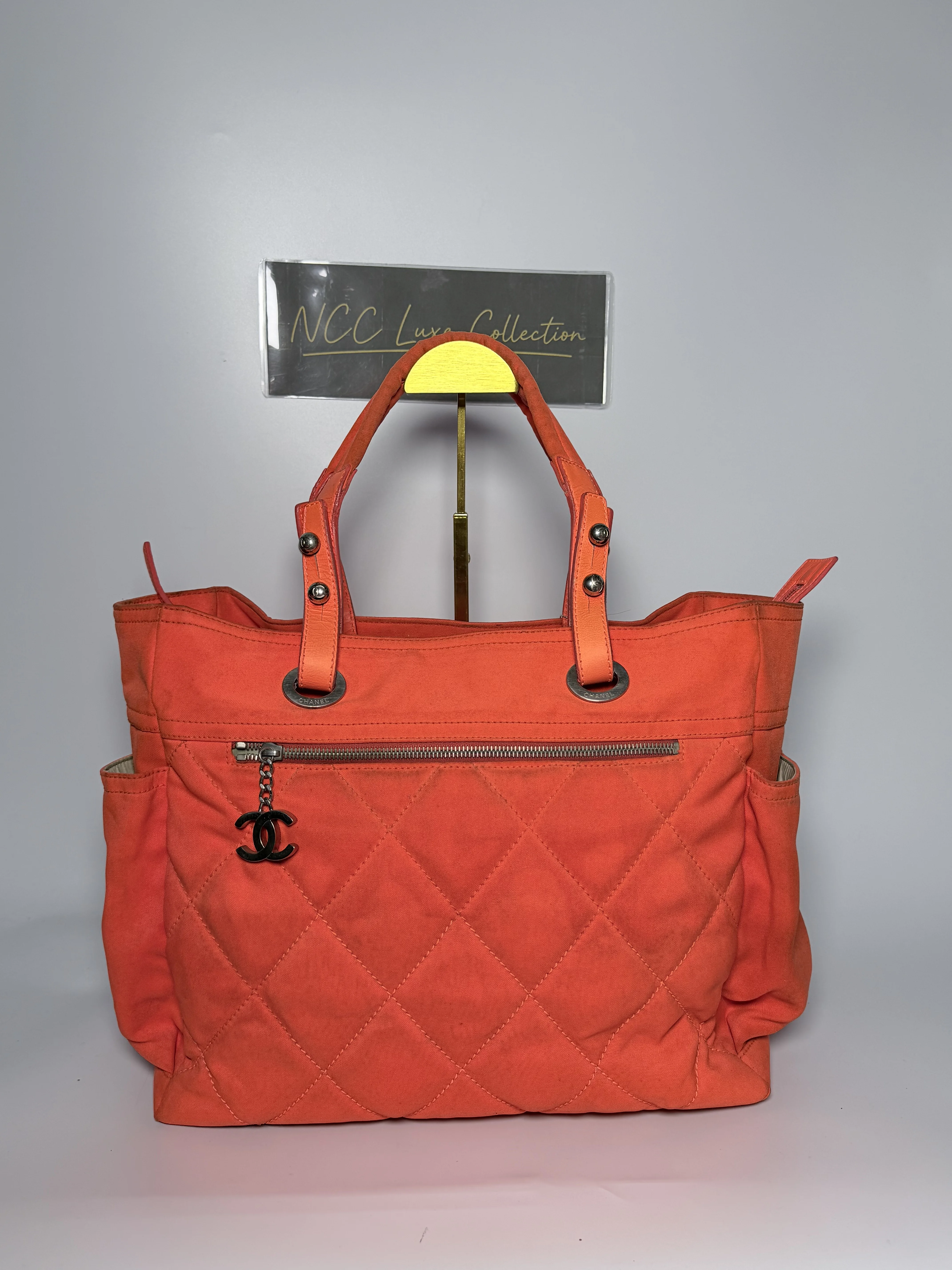 Chanel Paris Biarritz Tote Bag in orange quilted canvas with a prominent CC charm